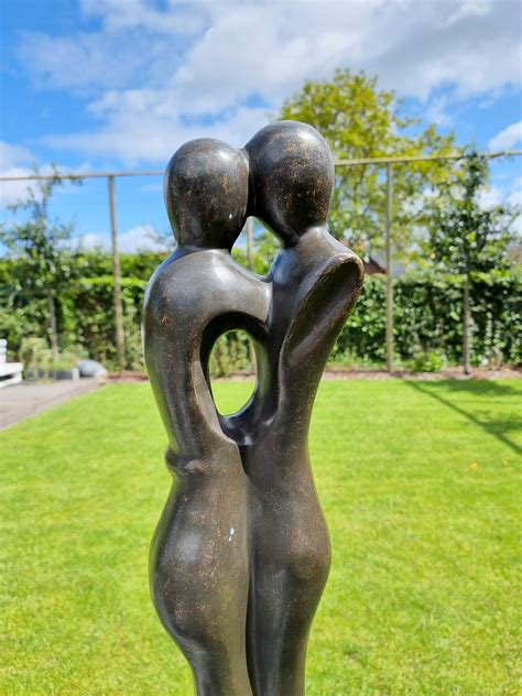 bronze garden sculpture   embracing couple abstract  modern