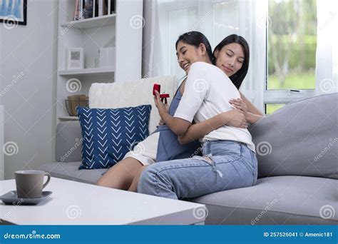 Engaged Women Couple Hugging Each Other Lovingly In Living Room Lgbt