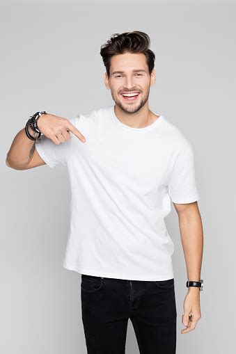 smiling young man pointing  stock photo  image  istock