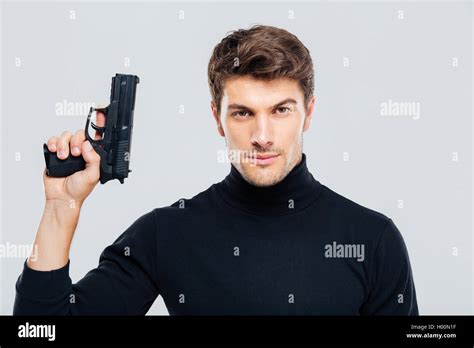 portrait  handsome young man holding  gun stock photo alamy