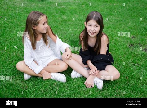 Fraternal Twins Sisters Blonde And Brunette Teen Girls In Fashionable