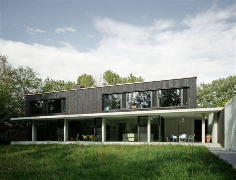 architecture   family house combines raw concrete  dark wood