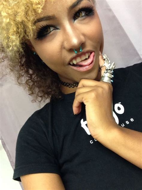 woman  curly hair  piercings   nose posing   camera  wearing  black