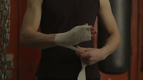 man bandaging his hand before boxing free stock video mixkit