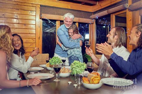 Friends Clapping For Couple Hugging Photograph By Caia Image Science