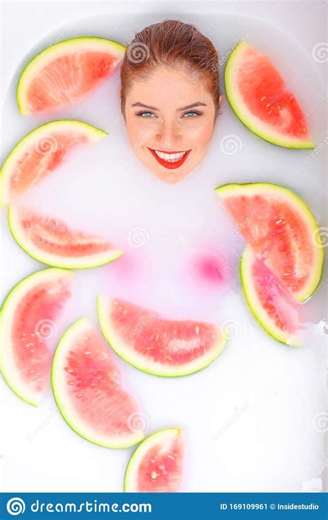 Portrait Of A Beautiful Red Haired Woman Takes A Bath With Milk And