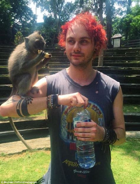 Michael Clifford Unveils New Blue Hair As He Poses With