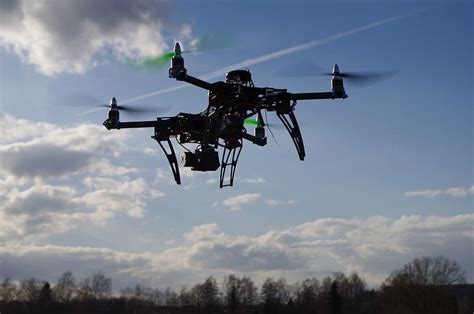 black quadcopter drone hovering drone quadrocopter aerial
