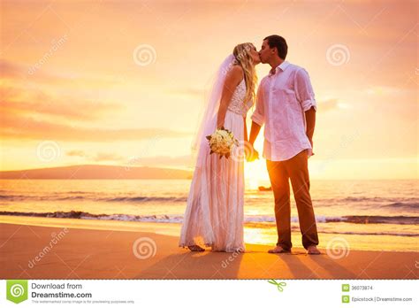 Bride And Groom Enjoying Amazing Sunset On A Beautiful