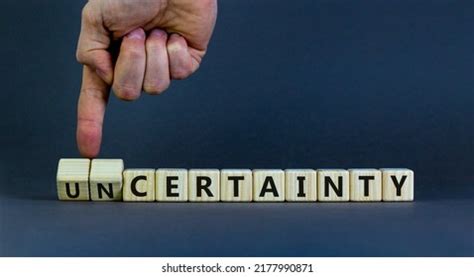 certainty uncertainty symbol businessman turns wooden stock photo