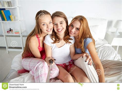 Teen Girls With Selfie Stick Photographing At Home Stock