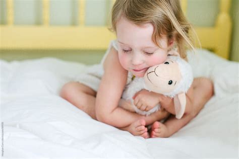 girl hugging  stuffed animal  stocksy contributor