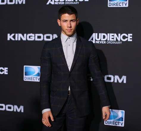 nick jonas steps out in dapper suit following flaunt photo reveal the