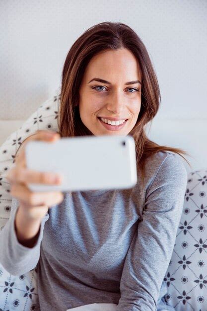 Free Photo Smiling Woman Taking Selfie In Bed