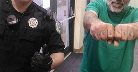 police smile at cops suck tattoo across man s knuckles