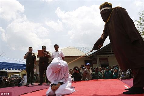 indonesian woman is whipped in front of a crowd because she had been