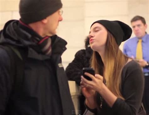 girl attempts to kiss strangers in grand central station on camera