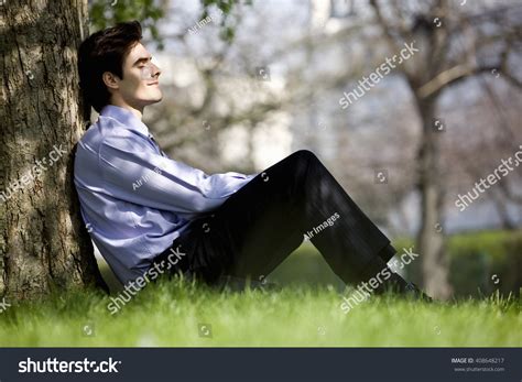 businessman leaning   tree resting stock photo  shutterstock