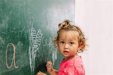 premium photo  child draws   blackboard   teacher