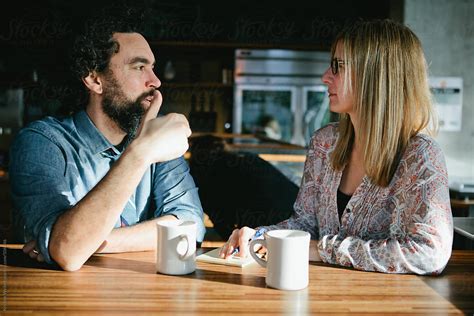 Man And Woman Having A Conversation Over Coffee In A Cafe Del
