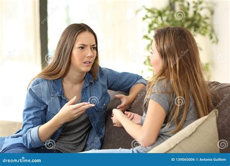 women talking   couch  home stock photo image  annoyed