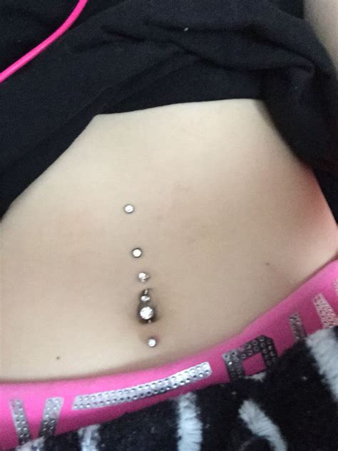 Top And Bottom Belly Button Piercings With Two Dermals On Top Belly