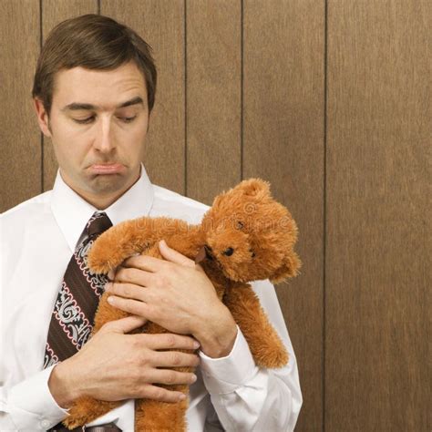 man holding  stuffed animal stock images image