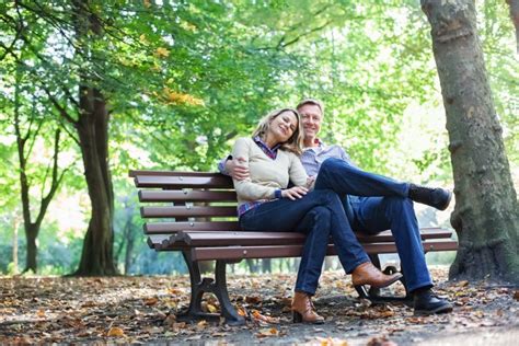 affectionate couple sitting on a park bench catholic life insurance