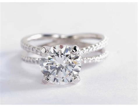 This Platinum Engagement Ring Features Two French Pavé Set Bands That