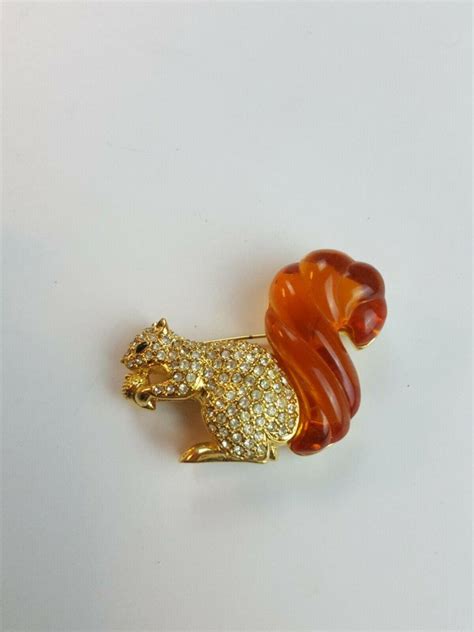 swarovski rhinestone and amber lucite squirrel nolan miller brooch pin