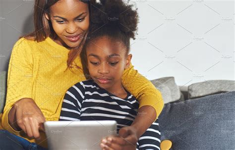 black mom and daughter learning on tablet people images ~ creative market