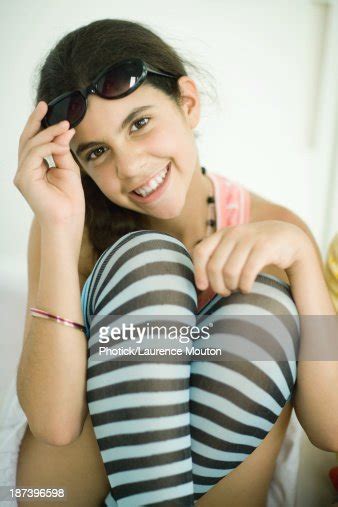 Preteen Girl Wearing Striped Knee Socks Lifting Sunglasses Portrait