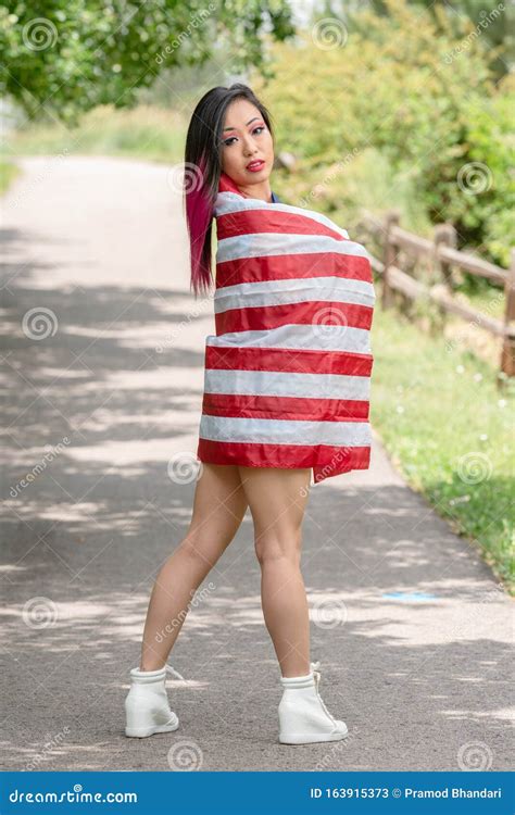 beautiful asian girl posing in the american independence day stock