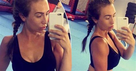 lauren goodger flashes rock hard abs in sports bra and tight lycra for