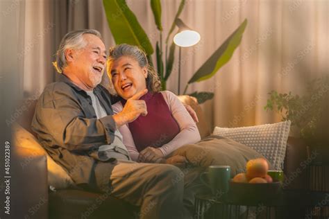 old retired age asian couple watching tv at home old mature asian