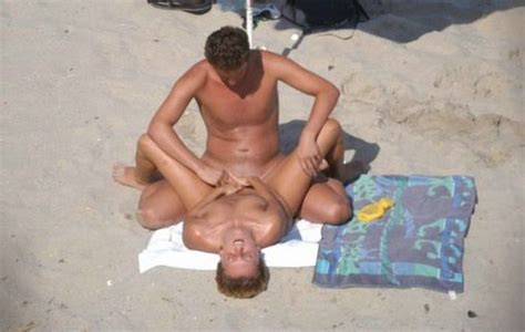 mature couple having sex on public beach photo