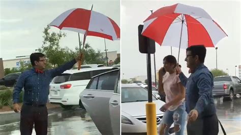 chick fil a employee holds umbrella for customers in pouring rain goes