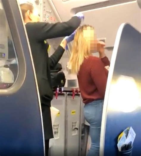 flight crew filmed wiping sick from woman s hair after