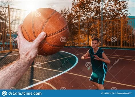 Sports And Basketball A Man`s Hand Holds A Basketball For
