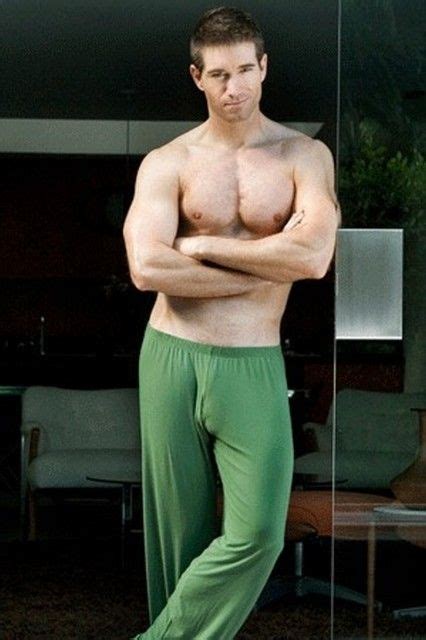 shirtless hunk wearing green lounge pants that cling to his delicious package the color of
