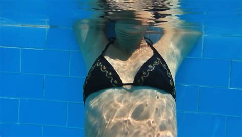 woman swim in blue pool underwater video stock footage