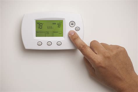 male hand  digital thermostat set   degrees murphy miller