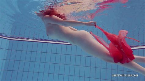 fire red haired girl katrin privsem swimming naked in a pool