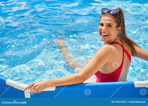 Close Up View Of Attractive Woman Relaxing On Swimming Pool In The