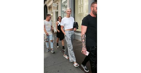 karlie was seen wearing gray silk trousers and a white crop top model