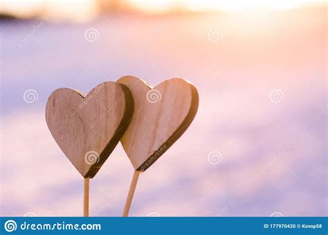 Silhouette Of Homemade Hearts In Nature During Calm Winter Sunset