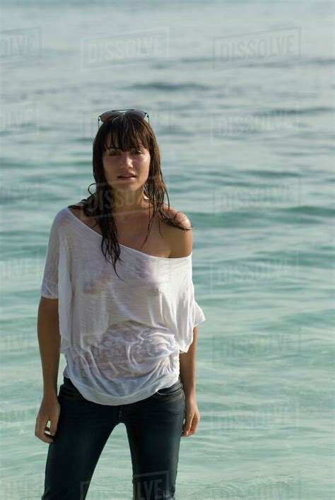 young woman wearing wet shirt  beach stock photo dissolve