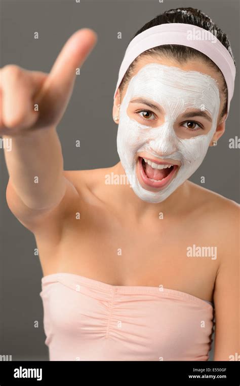 teenage girl facial mask beauty thumb up shouting on gray background