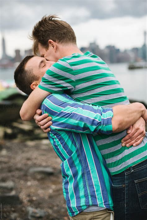 happy gay couple hugging outdoors del colaborador de stocksy simone