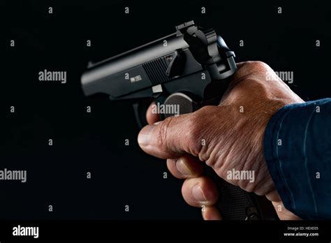 person holding handgun   black background stock photo alamy